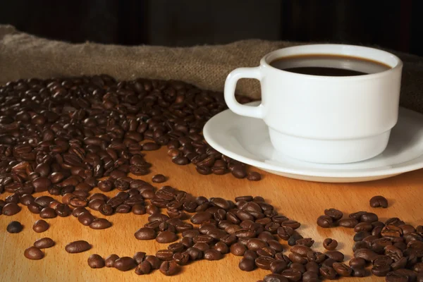 ถ้วยกาแฟที่มีผ้าคลุมในพื้นหลัง — ภาพถ่ายสต็อก