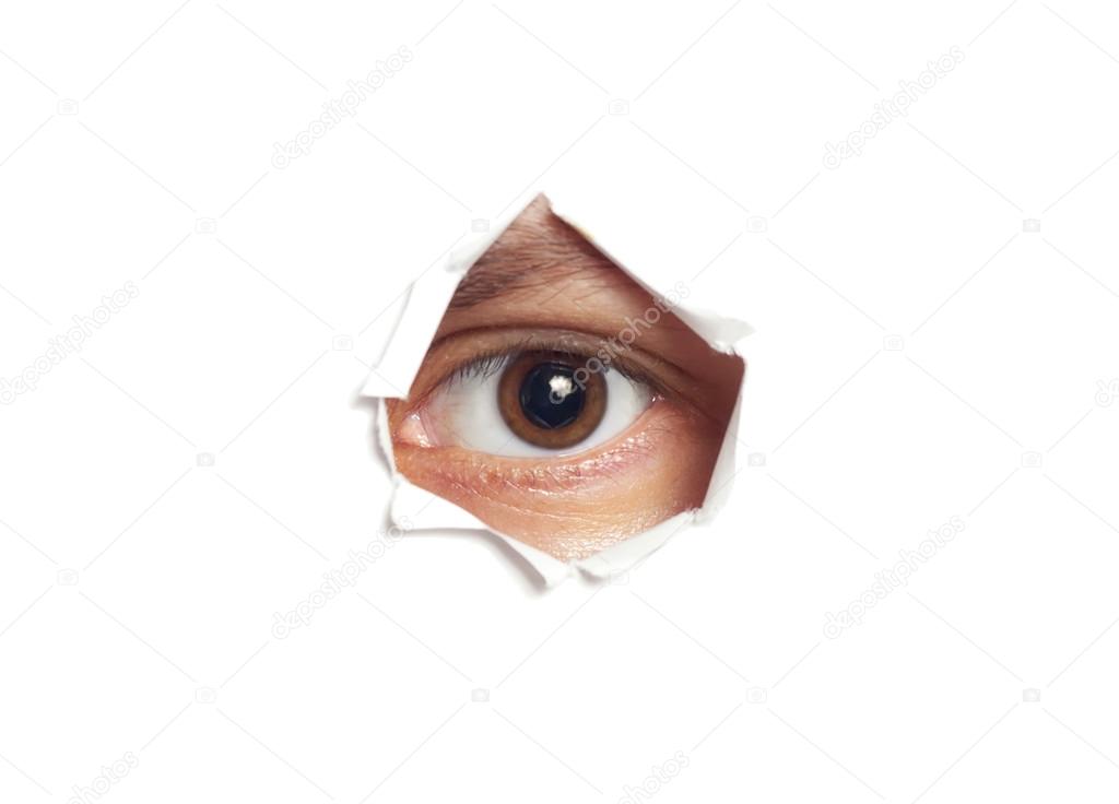 Human eye looking through a hole