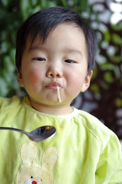 A cute baby is eating in restaurant — Stock Photo, Image