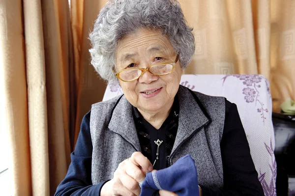 Sewing grandmother — Stock Photo, Image