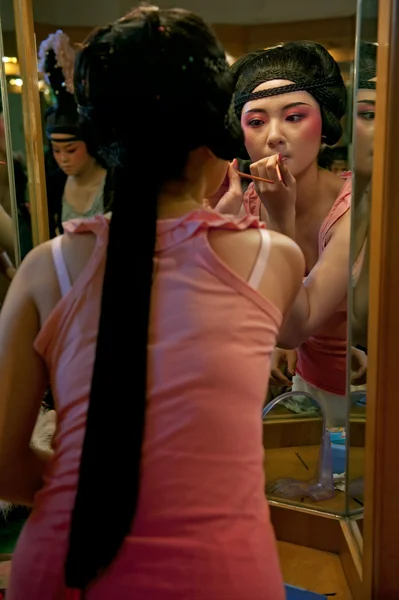 Chinese opera actress painting face at backstage — Stockfoto