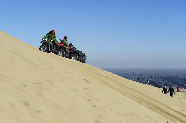 Moto man in sand dunes — Stock Photo, Image