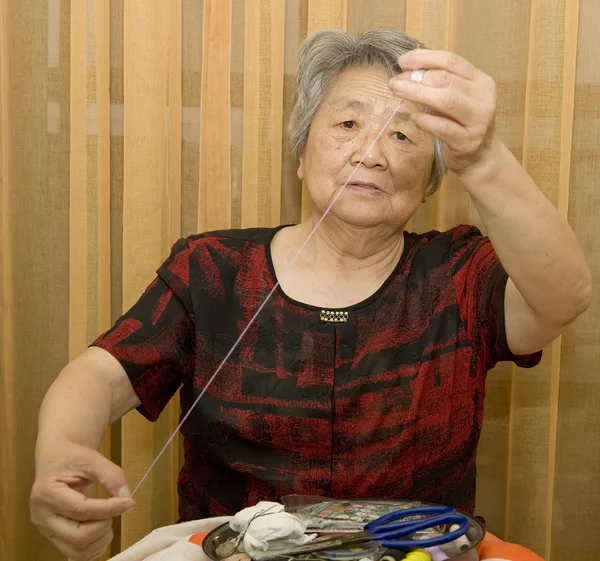 Sewing grandma — Stock Photo, Image