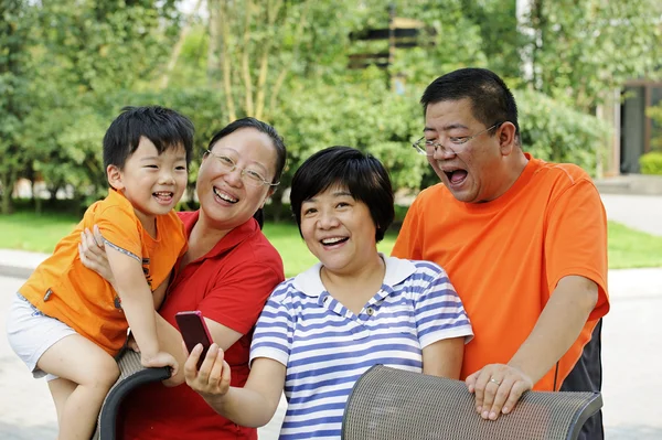 Happy kid playing with his uncle and aunt — Stock Photo, Image