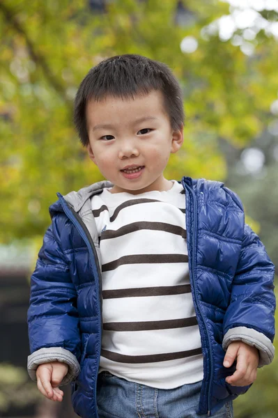 A cute baby is playing in a park — Stock Photo, Image