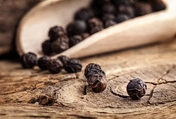 Black pepper on the wooden table — Stock Photo, Image
