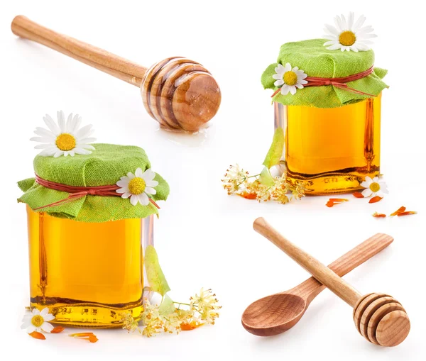 Honey in glass jar and wooden honey dipper — Stock Photo, Image