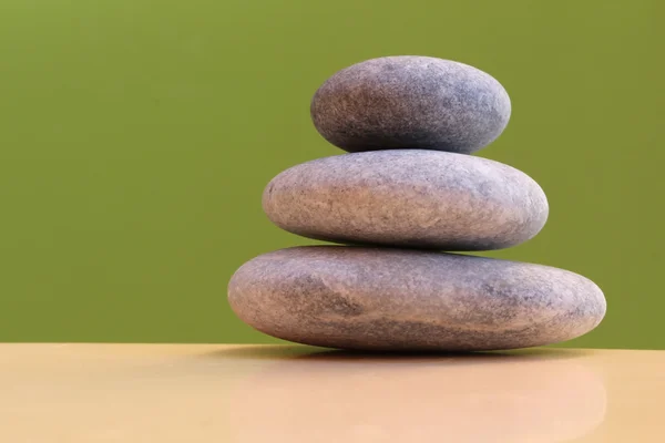 Three stones on green background - harmony — Stock Photo, Image