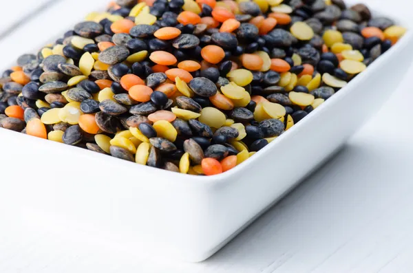 Variety lentils in porcelain plate — Stock Photo, Image