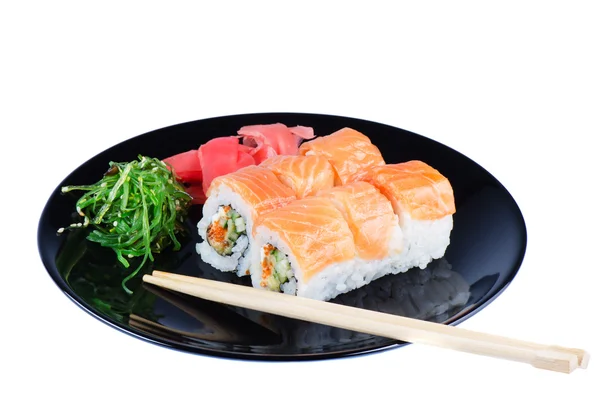 Black plate with sushi and chopsticks — Stock Photo, Image