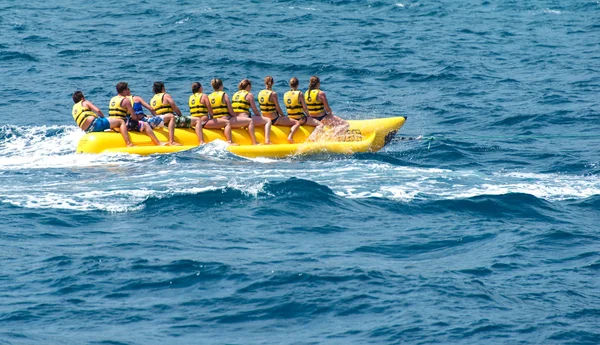 Riding banana boat at sea — Stock Photo, Image