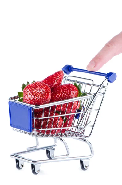 Miniatuur winkelwagentje met aardbeien en vinger — Stockfoto
