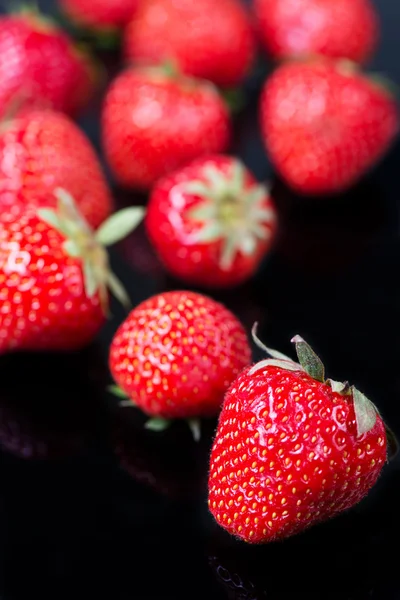 Fresh strawberries on black — Stock Photo, Image