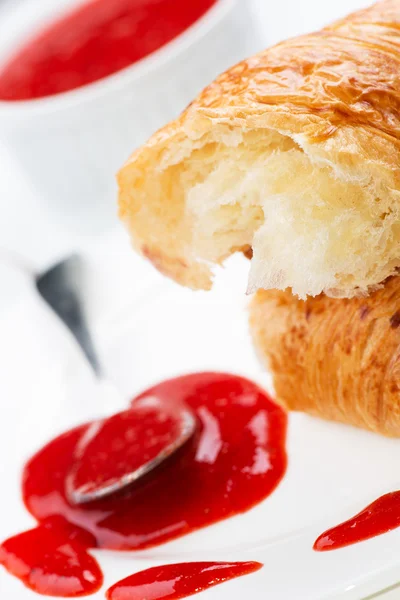 Croissant and strawberry jam in bowl — Stock Photo, Image
