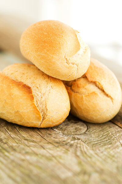 Pile of Bread on wooden table close up