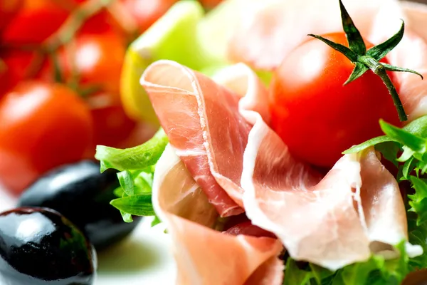 Sandwiches with prosciutto on plate with olive close up — Stock Photo, Image
