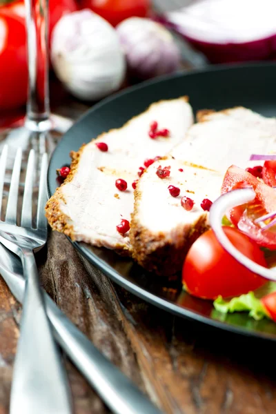 Set of oven baked pork in plate with salad close up — Stock Photo, Image