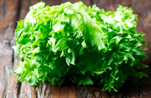 Green lettuce on wooden table — Stock Photo, Image