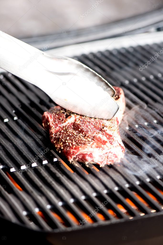 grilling steak on BBQ