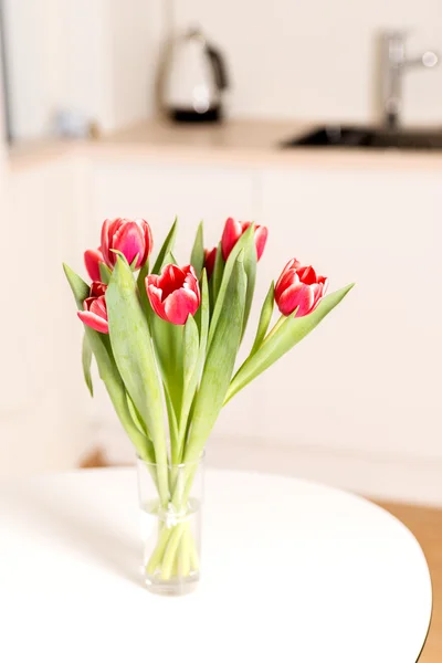 Tulips bouquet in glass — Stock Photo, Image