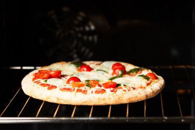 Cooking pizza in oven copy space clipart