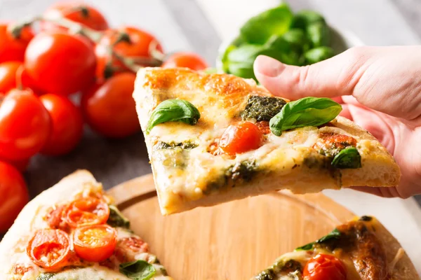 Italian pizza  with tomatoes and hand — Stock Photo, Image