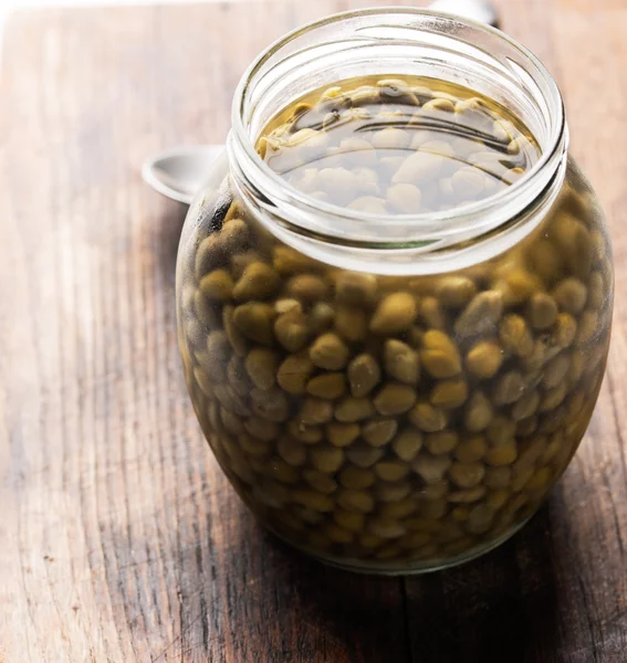 Capers in glass jar — Stock Photo, Image