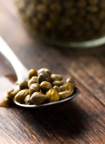 Pickled capers in spoon — Stock Photo, Image