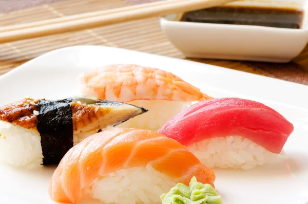 Sushi and soy sauce on white plate — Stock Photo, Image