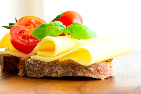 Sandwich with cheese tomatoes and basil