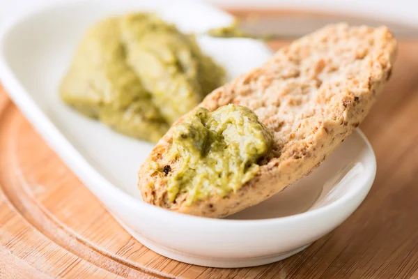 Toast with pesto sauce in bowl — Stock Photo, Image