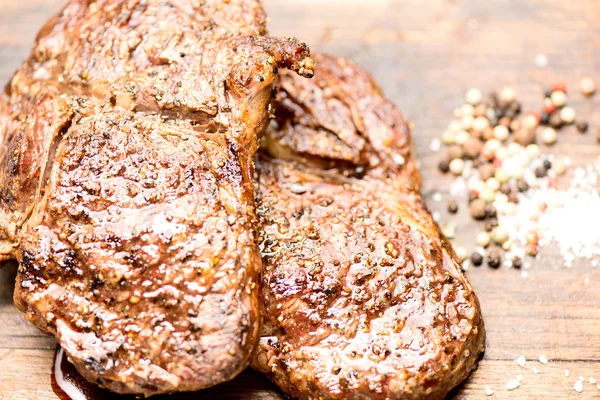 Grilled steaks with salt and pepper — Stock Photo, Image