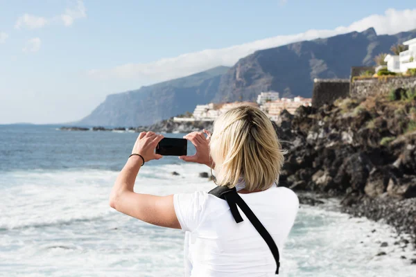 Woman taking picture by phone — Stock Photo, Image