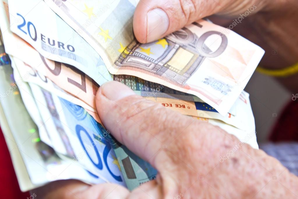 Hands counting euro banknotes