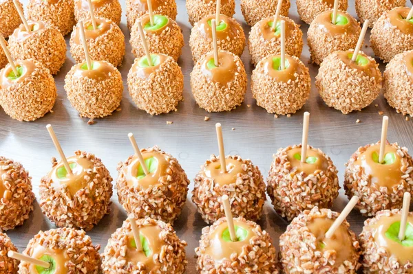 Batch of caramel apples with nuts