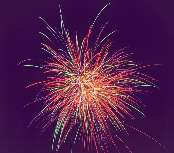 Fireworks of various colors over dark sky. soft focus. — Stock Photo, Image