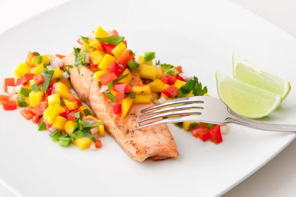 Salmon fillet with mango salsa on white plate. — Stock Photo, Image