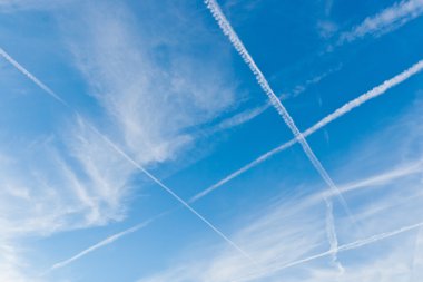 Sky with crossing vapor trails clipart
