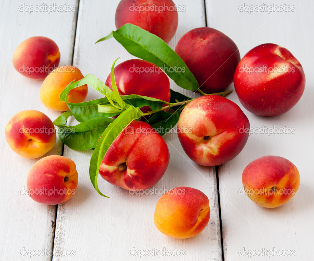 Colorful summer fruits - apricots, nectarines and peaches on woo