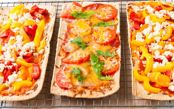 Backed flatbread with variety of toppings. — Stock Photo, Image