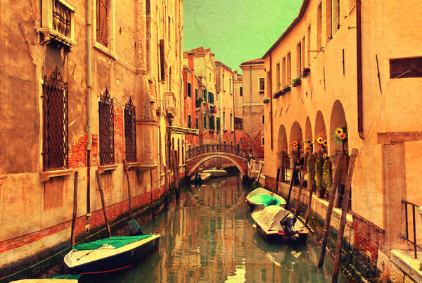 Vintage style image - Venice narrow water canal and traditional