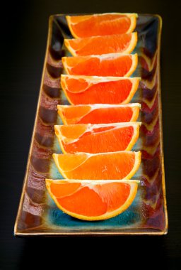 Slices of  the cara cara oranges with its pinkish red color inte clipart