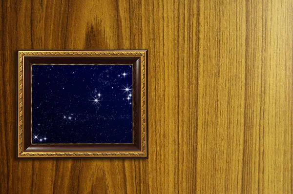 A photo of a wooden picture frame with the night sky setting ins — Stock Photo, Image