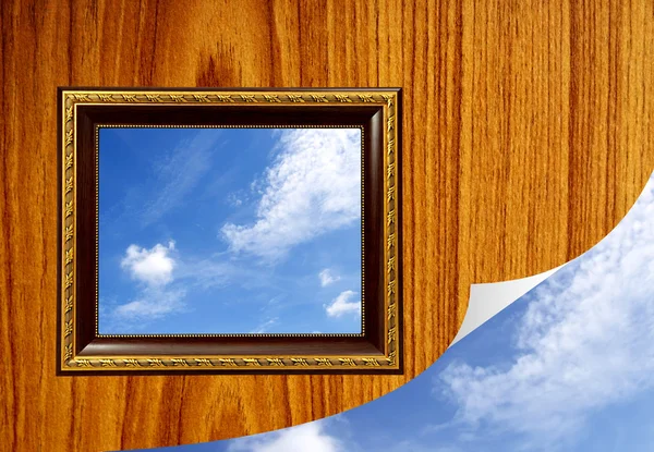 A photo of a wooden picture frame with the sky setting inside — Stock Photo, Image