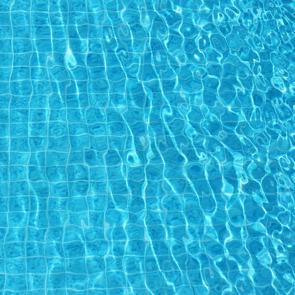 Blue rippled water background in swimming pool — Stock Photo, Image