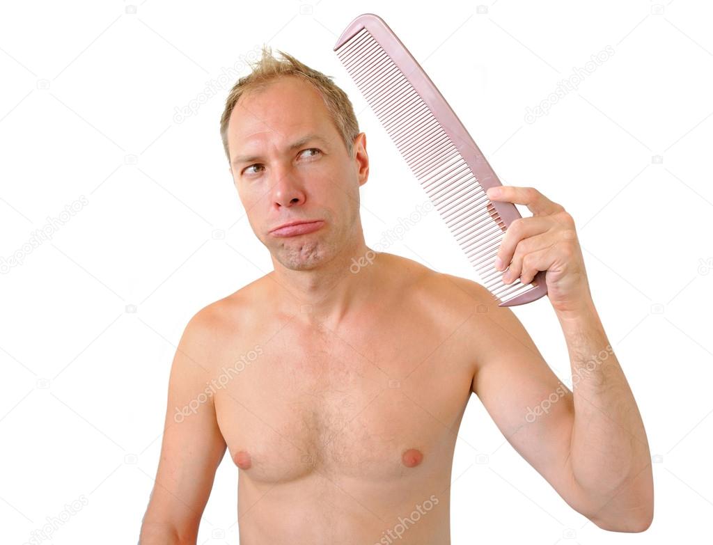 Bewildered man hand holding comb on the head