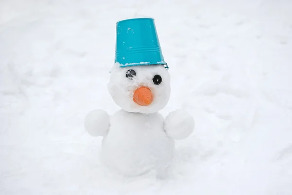 Snowman with blue bucket on the head — Stock Photo, Image