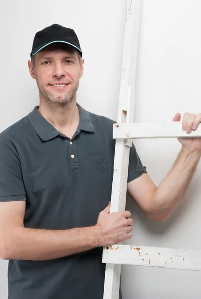 Worker man hold a ladder — Stock Photo, Image