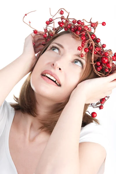 Pretty woman in wreath of red berries — Stock Photo, Image