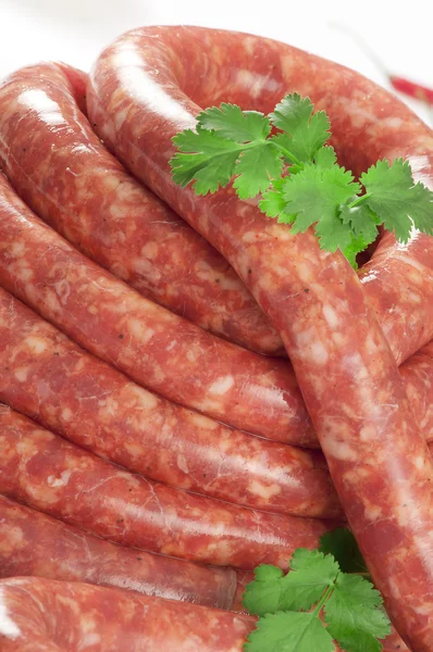 A natural raw sausage on white — Stock Photo, Image